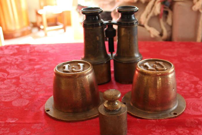 Lot #13 Vintage Brass items
Very old brass Binoculars 
Round brass cups - not sure what these are:  ideas are: glass embossing stamp, or die for casting new stamps.  They are heavy! 
Brass weight