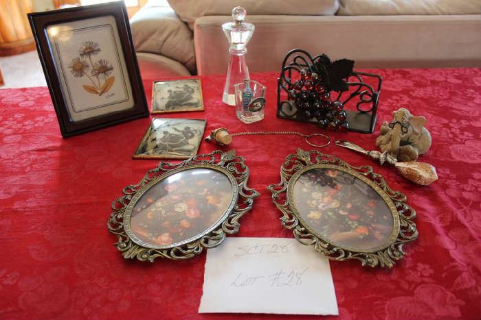 Lot #28 Home Décor Items
Aster Picture in wood frame
2 - matching vintage winter scene pictures
Crystal perfume bottle
Dale Earnhard shot glass & key chain
Grapes & leaves wine stopper
Shell handled cheese serving knife
Frumps elephant figurine
Metal grape & leaf napkin holder
Two matching oval floral pictures - made in Italy