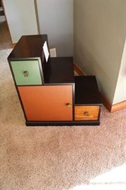 Lot #37 Decorate that unused corner of your home with this small graduated wood cabinet with shelves & two drawers. Dark brown, orange & green
24x24x15