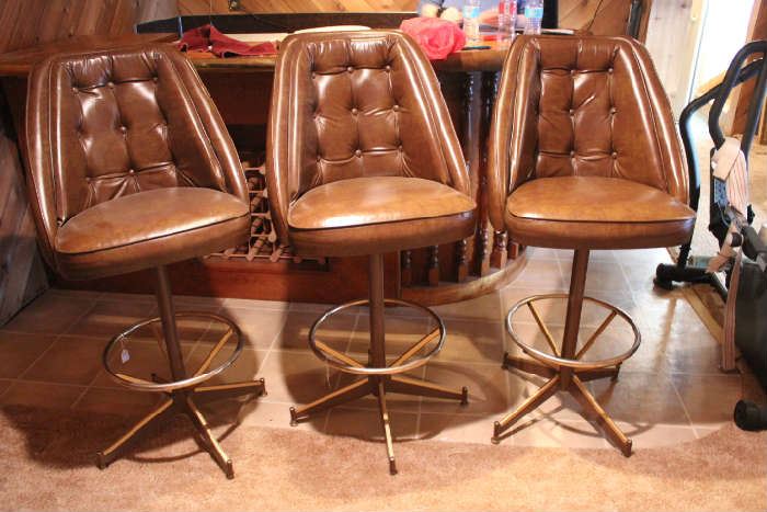 Lot #78 Three brown high-back swivel bar stools with food rests in excellent condition. 47 in H x 23 in W x 24in D