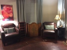Brown Leather Club Chairs, Small Shelf, Stenciled Wood Fireplace Screen, Small Black Table, Floor Lamp, Table Lamp.