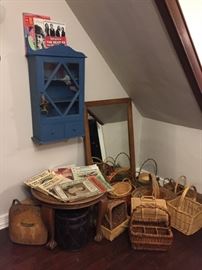 Blue Wall Shelf Cabinet, Round Walnut Side Table, Mirror, Baskets, Vintage Magazines.
