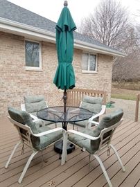 Patio table. Four patio chairs. New LIGHTED patio umbrella!!!