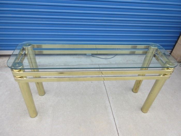 Glass top with gold tone brass-like legs sofa table