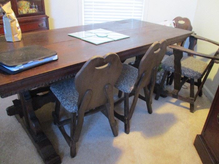 Antique Irish pub table with chairs and a bench