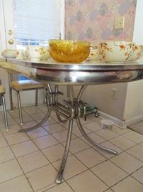 Mid Century Modern chrome and Formica table with six chrome and vinyl chairs.  Includes a leaf.  Excellent condition!
