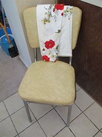 Vintage table cloth, and one of he six vinyl Mid Century Modern chairs