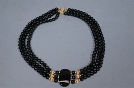 Lot 211 14K Gold Triple Strand Onyx Bead Necklace. Lozeng