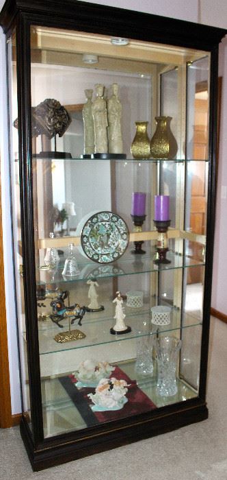 This is a lovely curio, lit, glass shelves that enter from the sides.  Super nice display piece that can meld with any decor.