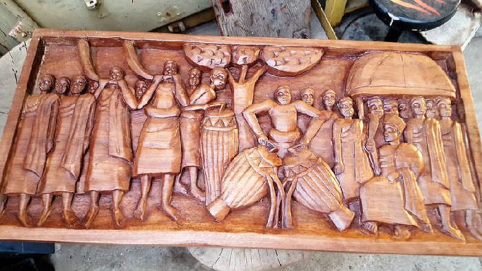 This is a beautiful large and quite heavy wood carving depicting an African seen.  Measures about 46"wide x 21-3/8"tall.  