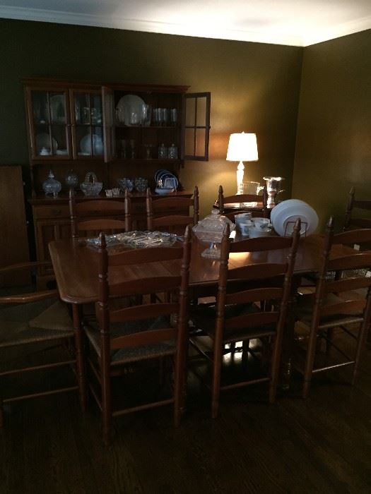 Cherry drop leaf, gate leg dining table with 2 additional leaves and custom table pads.  8 matching chair with rush seats - perfect condition and beautiful. 