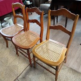 Large collection of caned vintage chairs