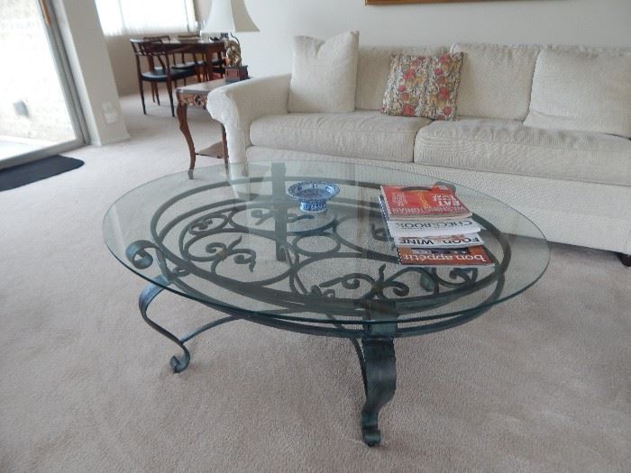 Large oval glass and iron coffee table.