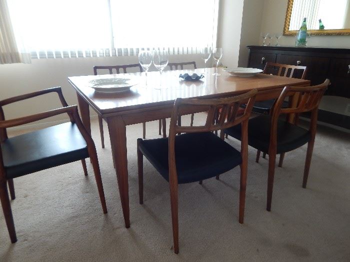 Mid Century dining table/ 6 chairs.  Table has tuck away leaves. 2 arm chairs/ 4 side chairs with leather like fabric seats. All in good condition.