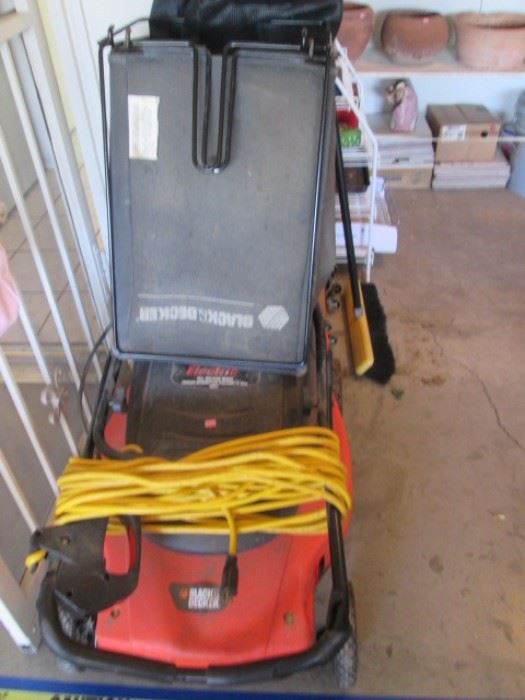 Electric lawnmower with extension cord and bag