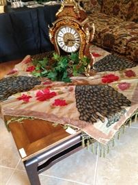 Fringed cloth, coffee table, and decorative clock