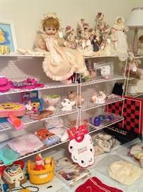 Variety of baby items, games, and dolls