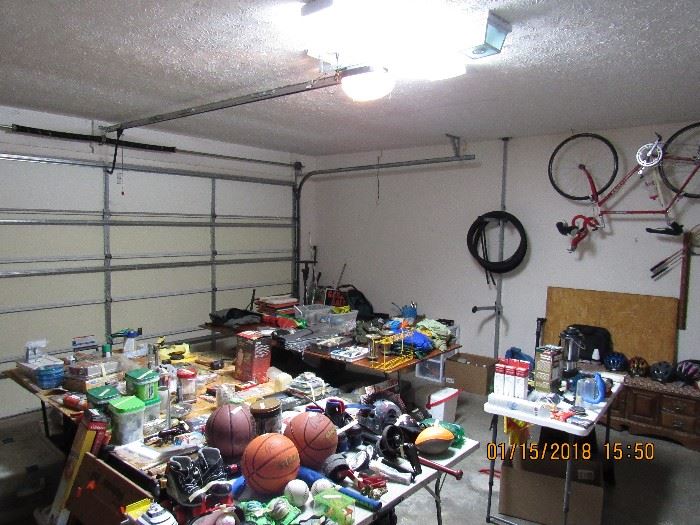 Garage full of hardware, toys, camping supplies, cycling supplies