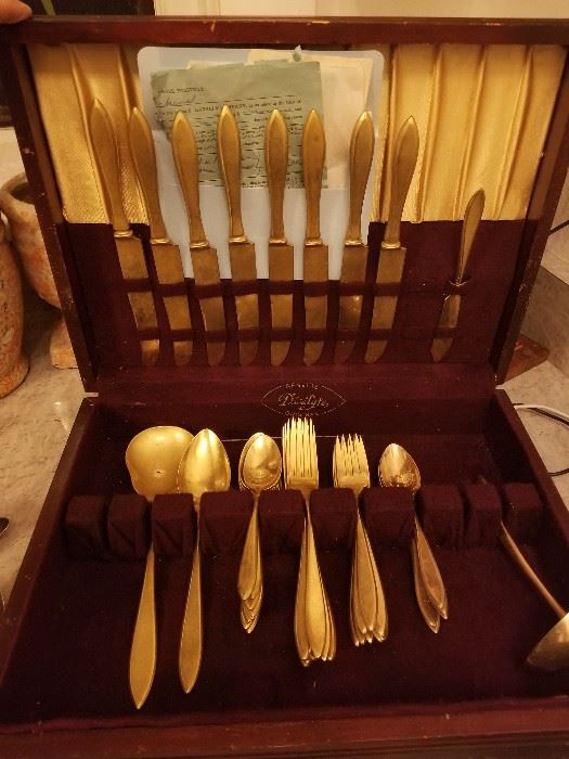 Gold plated dirilyte set 8-9 pieces each, original bill of sale from 1955