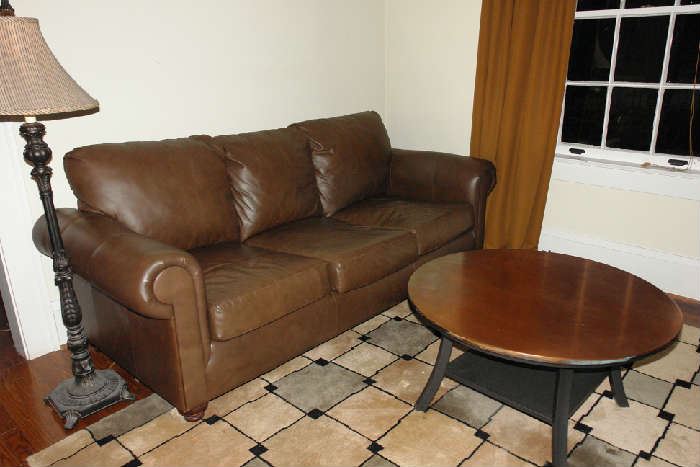 Leather sofa and copper top coffee table