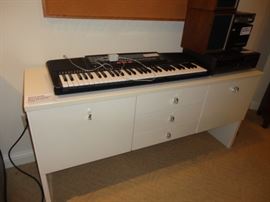 casio keyboard and white dresser cabinet