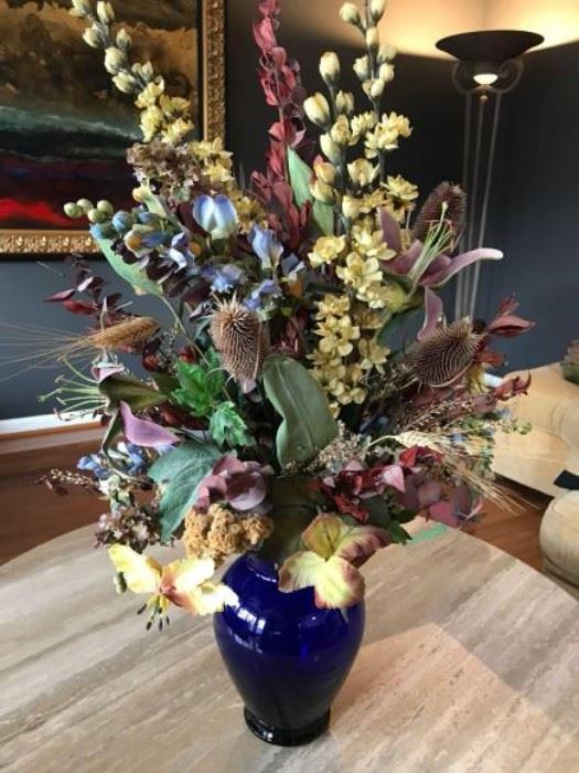 Elegant silk floral arrangement  in blue glass vase