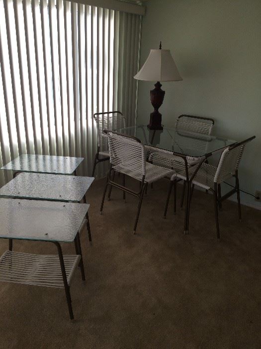 glass patio table with 4 chairs and 3 side tables.  60's. Excellent shape