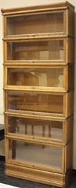 LOT #150- MACEY OAK STACKING SIX SECTION BOOKCASE W/ DRAWER