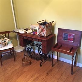 Antique sewing table.  Modern Singer sewing machine.  Accessories