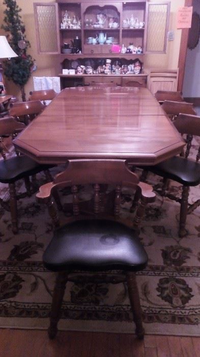 Table setting for 8!!!! Eight barrel back leather chairs. Two table leaves. This table has seen alot of love and a lot of use. At least 50+ years old!