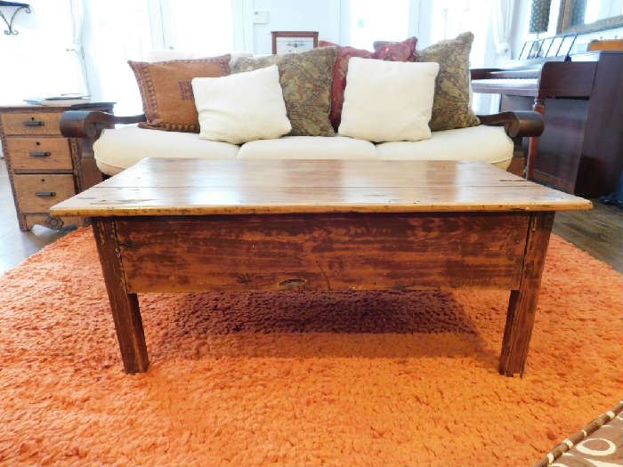 Surya Orange Shag rug under a primitive plank coffee table.