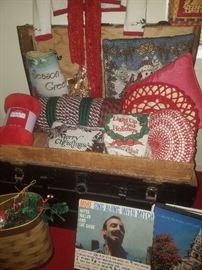 Black storage trunk with insert, Christmas linens/pillows, and albums. 