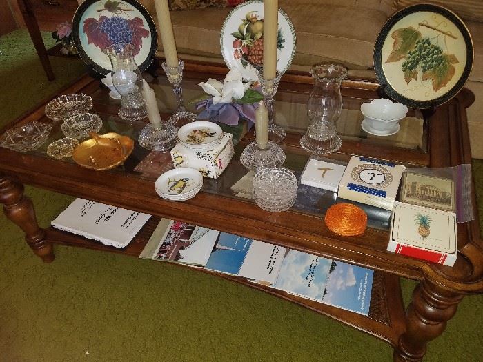 Oversized coffee table with bottom shelf & 4 glass inserts, decorative plates, coasters, ashtrays, candlesticks, & more.