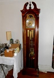 Howard Miller grandfather clock, solid wood cabinet, chimes every qtr. hour.  64" tall.  Needs adjustment.