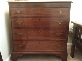 One of a pair of vintage mahogany butler's chests, with slide-out shelf.