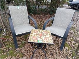 Great little tile-topped table, with curlicued cast iron base, flanked by a couple of all-weather outdoor armchairs.                                                                                                  
All you need is some microbrew beer, a Longaberger basket full of pretzels and a cozy fire to while away the winter days.