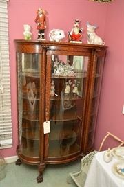 Tiger oak, bow-front china cabinet, Hull pig, other pig figurines