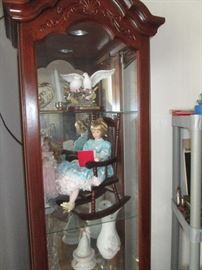 Ashton Drake dolls and a nice lighted curio cabinet