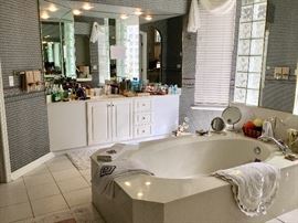 Bathroom with toiletries, mirrors etc