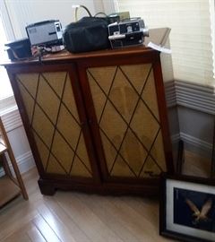 Vintage stereo cabinet, video camera, 35mm camera
