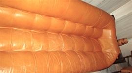 Closeup of leather sofa there is a 25 cent size repair mark that is hard to see unless close up