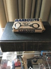 Old book and handcuffs