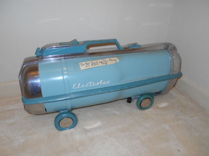 Antique Electrolux vacuum with hose.