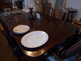 Mahogany Duncan Phyfe table and chairs with leaves, pads, and storage bags