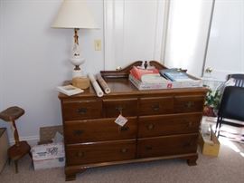 maple dresser with mirror, lamp, folding chair