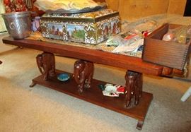 African coffee table supported by three carved elephants brought from Kenya.