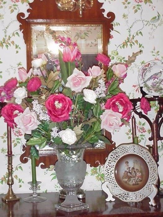 Huge silk floral arrangement in pedestal vase; Schumann reticulated plate, wood wall sconces
