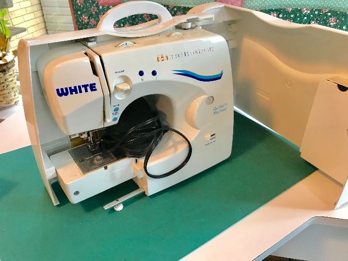 White quilter’s machine sewing
machine in case