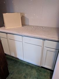Cabinetry with padded ironing board on top