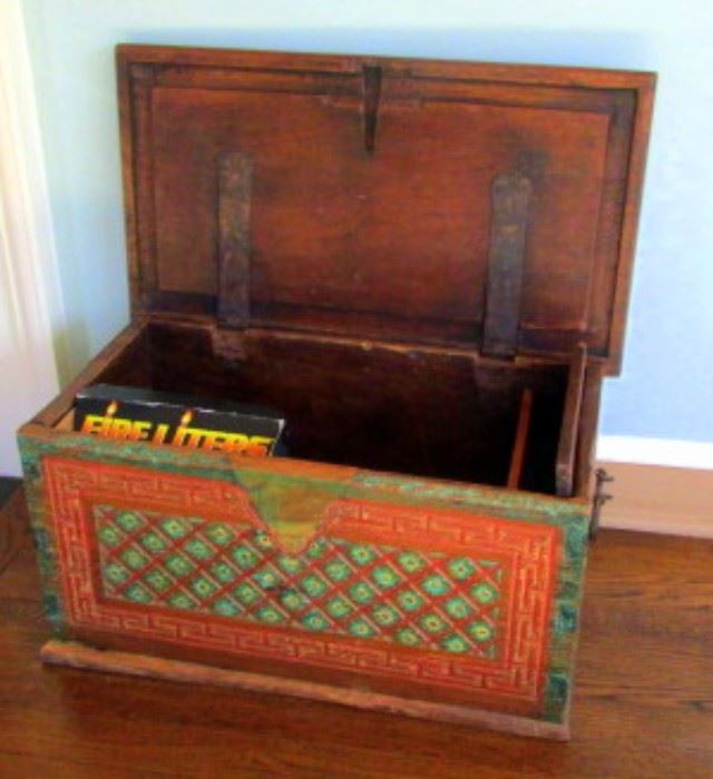 Small vintage wood chest with carved, Moorish design, now used as a kindling box next to fireplace